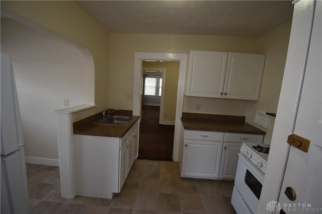 kitchen with white cabinetry, sink, and white appliances