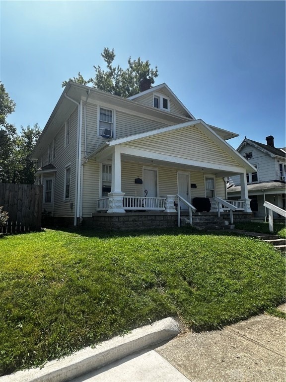 view of front of home with a front yard and a porch