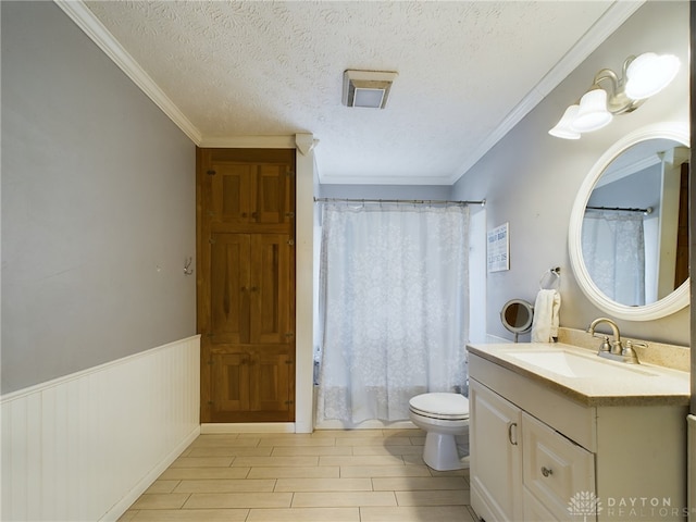 bathroom featuring a textured ceiling, vanity, toilet, ornamental molding, and hardwood / wood-style flooring