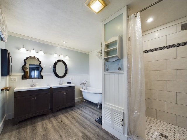 bathroom with vanity, ornamental molding, hardwood / wood-style floors, and plus walk in shower