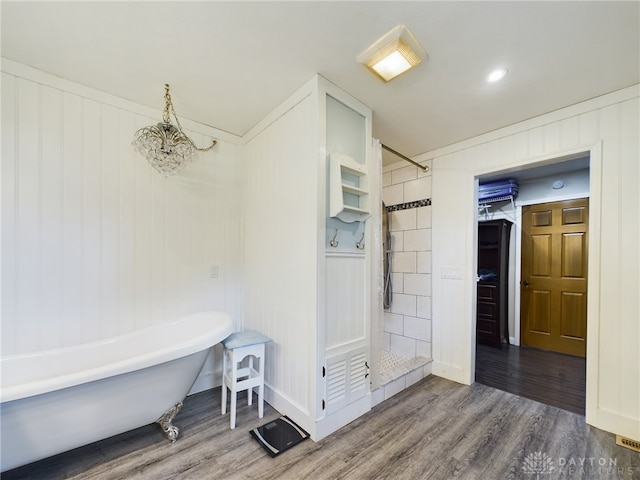 bathroom with crown molding, an inviting chandelier, wood-type flooring, and separate shower and tub