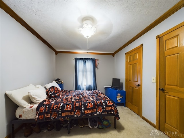 bedroom with crown molding, light carpet, and a textured ceiling