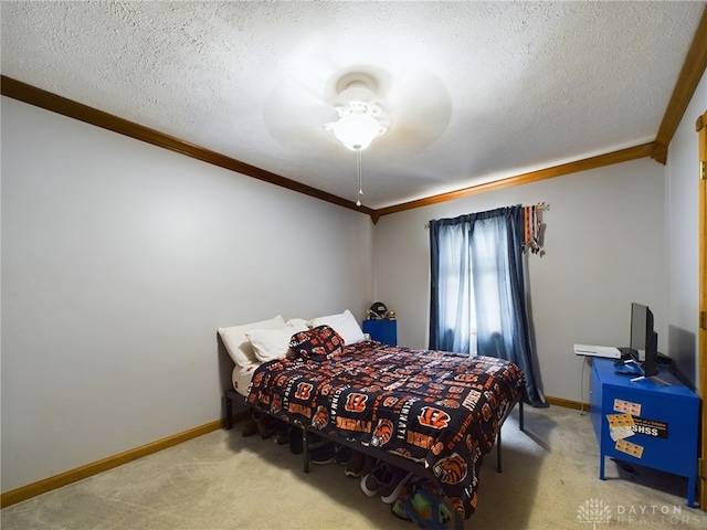 carpeted bedroom featuring ceiling fan, crown molding, and a textured ceiling