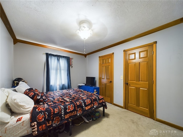 bedroom with a textured ceiling, carpet, ornamental molding, and ceiling fan