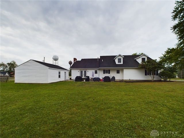 back of house with a lawn