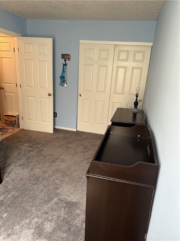 bedroom featuring a closet, carpet flooring, and a textured ceiling