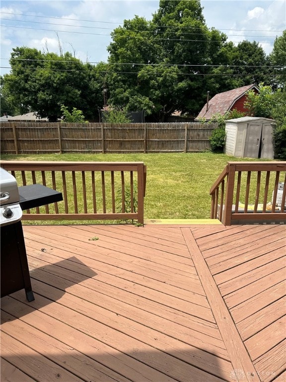 deck with a storage unit and a yard