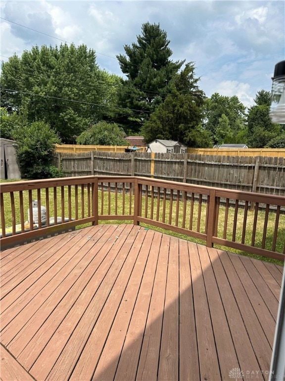 wooden terrace featuring a yard