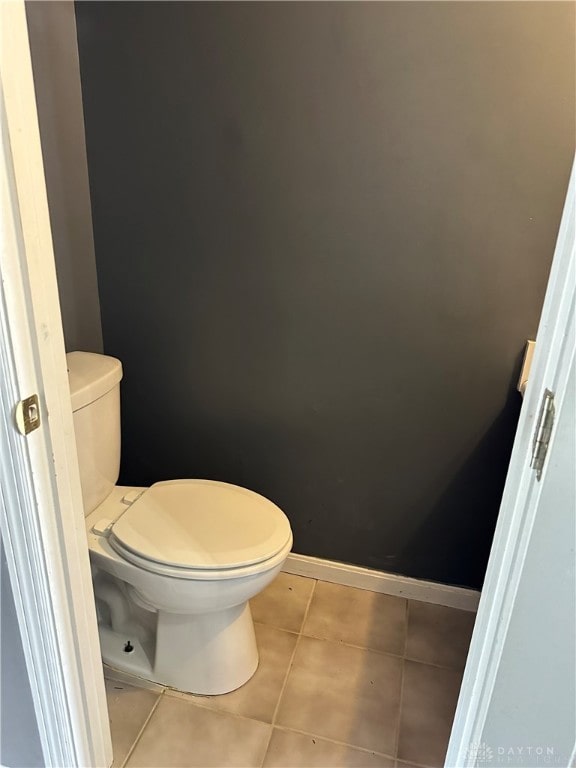 bathroom with toilet and tile patterned floors