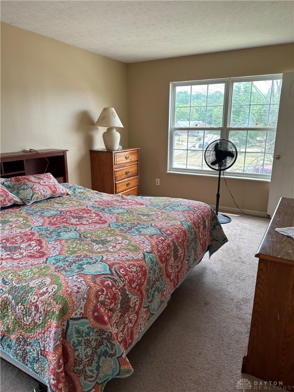 carpeted bedroom featuring a textured ceiling