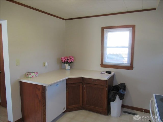 kitchen featuring range, dark brown cabinetry, and crown molding