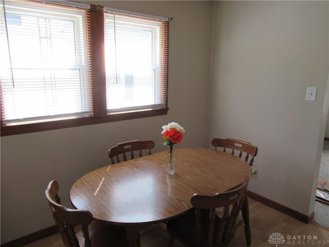 dining space with light hardwood / wood-style floors