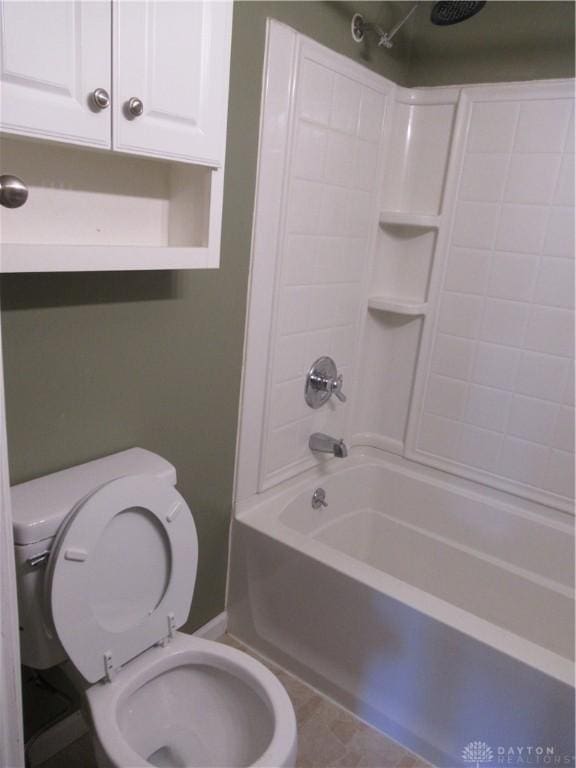 bathroom with tile patterned floors, bathtub / shower combination, and toilet