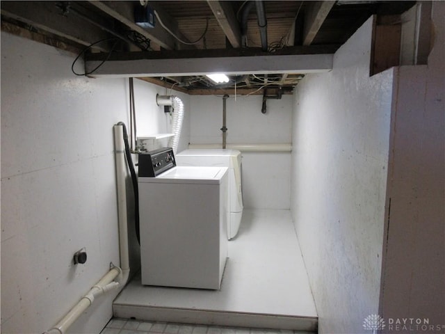 clothes washing area featuring washer and dryer