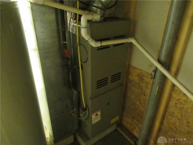 utility room featuring heating unit