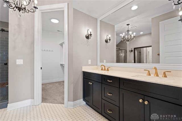 bathroom featuring an enclosed shower, an inviting chandelier, and vanity