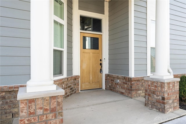 doorway to property featuring covered porch