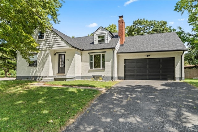 view of front of house featuring a front yard and a garage