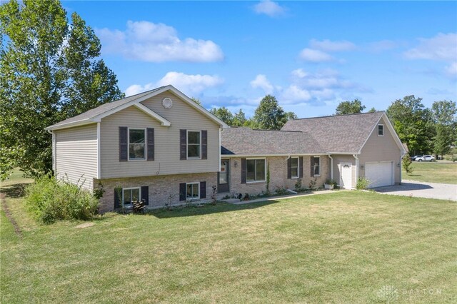 split level home featuring a garage and a front lawn