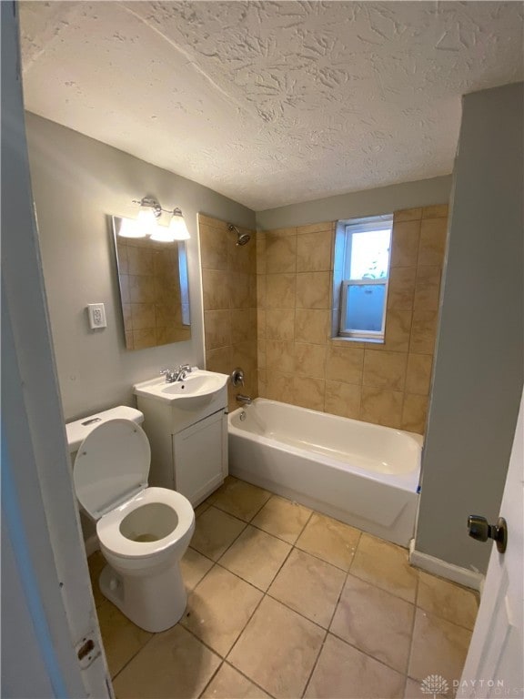 full bathroom featuring vanity, toilet, tiled shower / bath combo, and tile patterned floors