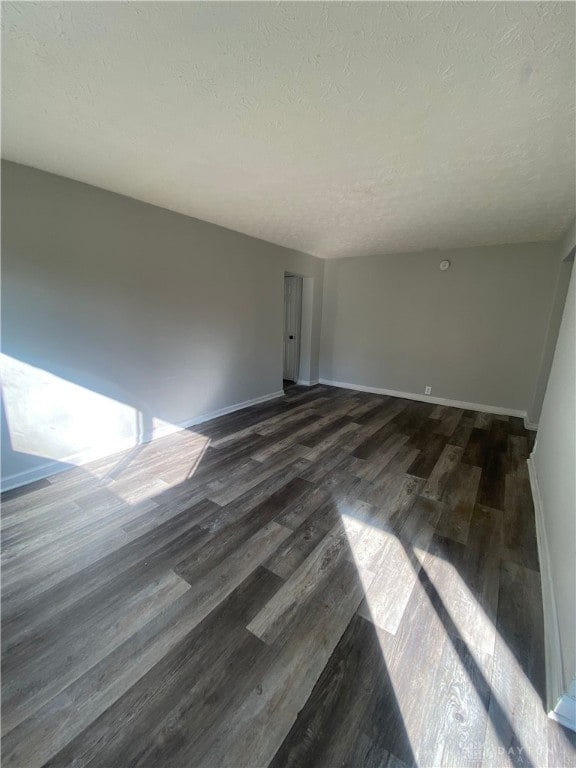 interior space featuring a textured ceiling and dark hardwood / wood-style flooring