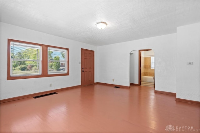 unfurnished room featuring a textured ceiling and hardwood / wood-style floors