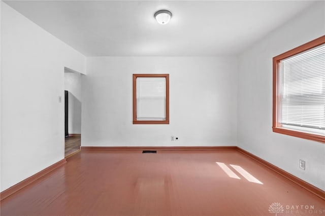 unfurnished room with hardwood / wood-style flooring