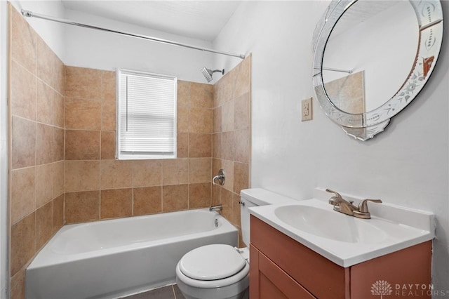 full bathroom featuring tiled shower / bath, toilet, and vanity