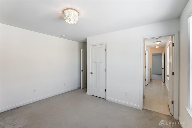 unfurnished bedroom featuring light carpet