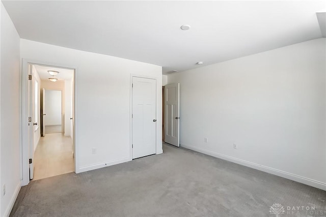 unfurnished bedroom with light carpet