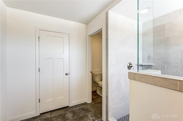 bathroom featuring toilet and a shower