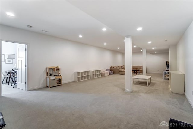 basement featuring light carpet