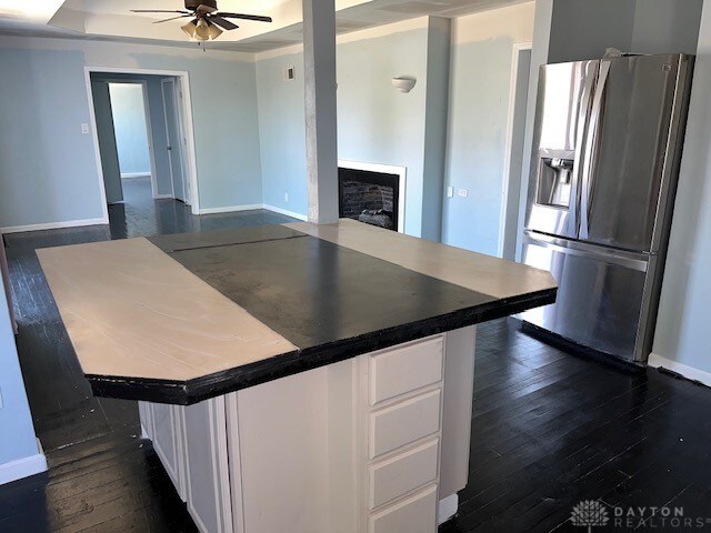 kitchen featuring white cabinetry, stainless steel fridge, ceiling fan, and dark hardwood / wood-style floors