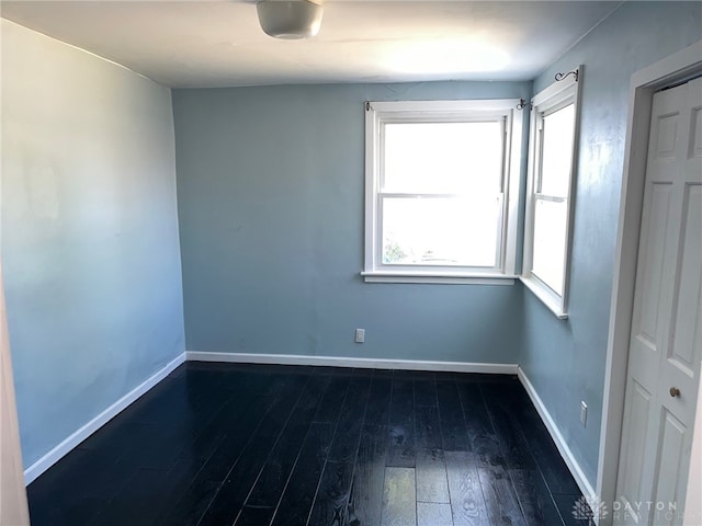 empty room featuring dark hardwood / wood-style flooring