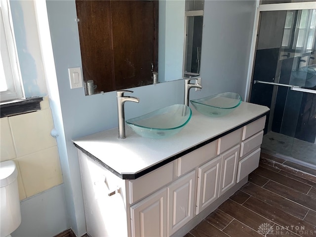 bathroom featuring vanity, toilet, and an enclosed shower