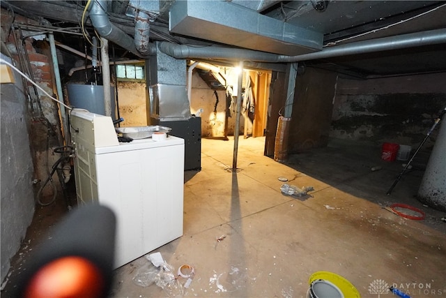 basement featuring washer / dryer, heating unit, and gas water heater