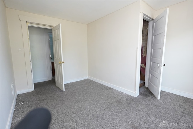 unfurnished bedroom featuring a closet and carpet flooring