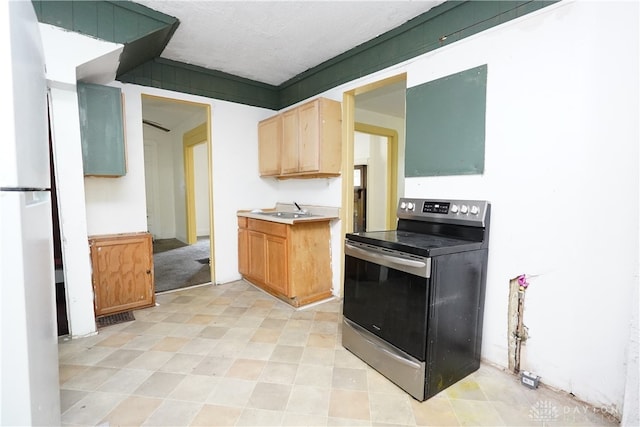 kitchen featuring light brown cabinetry, sink, white fridge, and stainless steel electric range oven