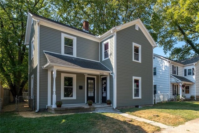 view of front facade with covered porch and a front lawn