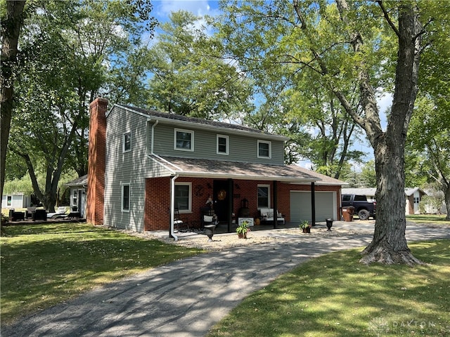 view of front of property featuring a garage and a front yard