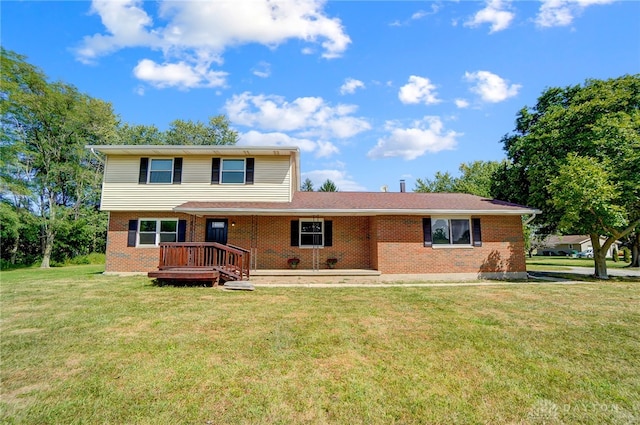 view of front of property with a deck and a front lawn