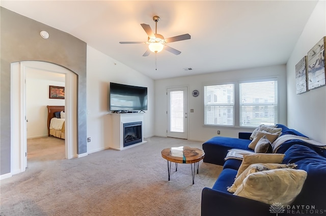 carpeted living room with lofted ceiling and ceiling fan