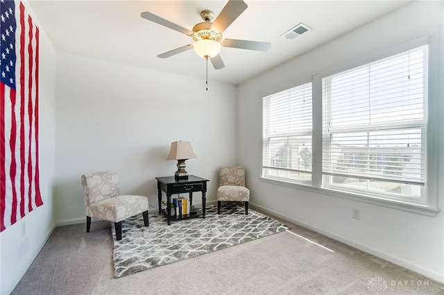 sitting room featuring ceiling fan and carpet