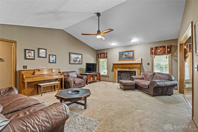 living room featuring lofted ceiling, ceiling fan, plenty of natural light, and carpet flooring