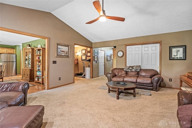 living room featuring lofted ceiling, ceiling fan, and light carpet