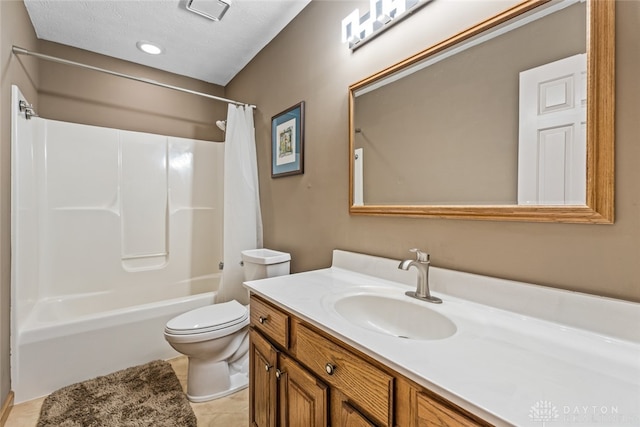 full bathroom featuring tile patterned floors, toilet, shower / tub combo with curtain, vanity, and a textured ceiling