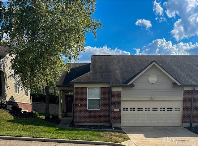 view of front of property featuring a front lawn and a garage