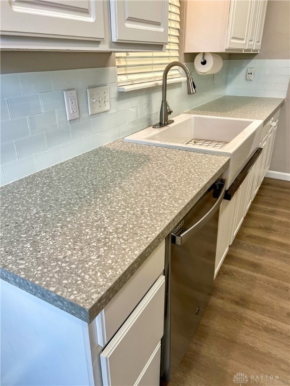 kitchen featuring dishwasher, dark wood-type flooring, sink, white cabinets, and tasteful backsplash