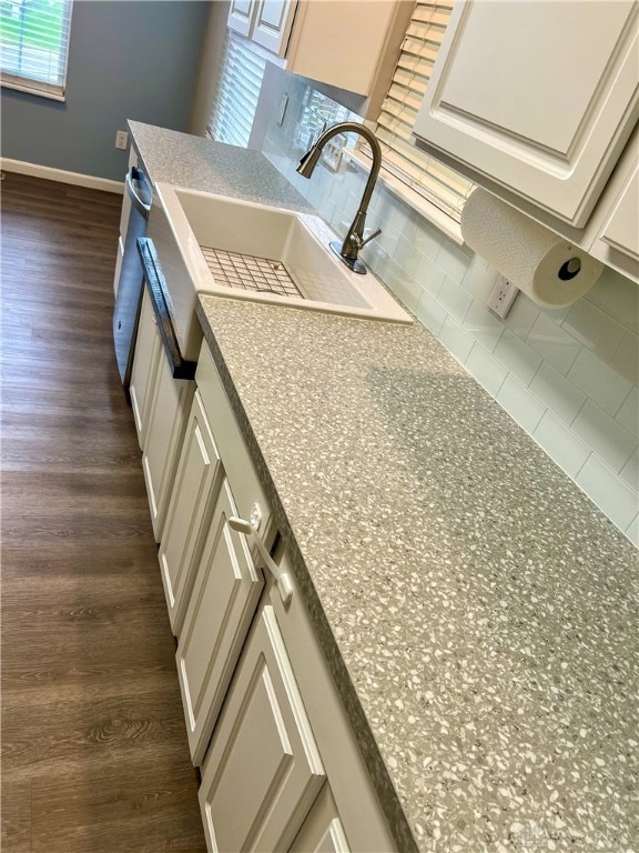 kitchen featuring white cabinetry, dark hardwood / wood-style flooring, and sink