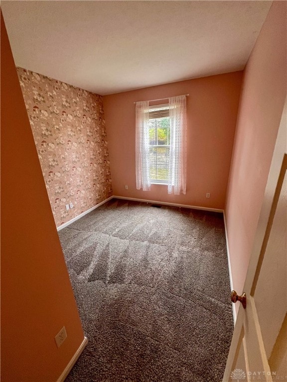 unfurnished room featuring carpet flooring